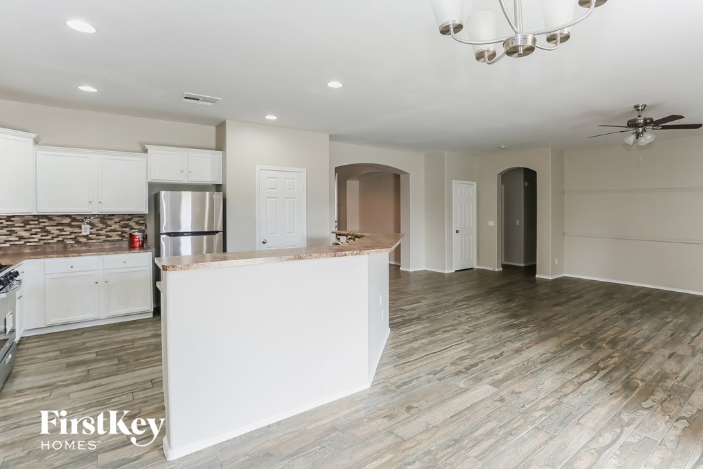 a renovated kitchen with white cabinets and a white counter top