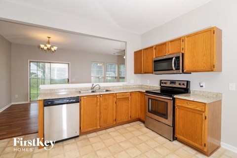 a kitchen with wooden cabinets and stainless steel appliances