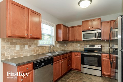 a kitchen with wooden cabinets and stainless steel appliances