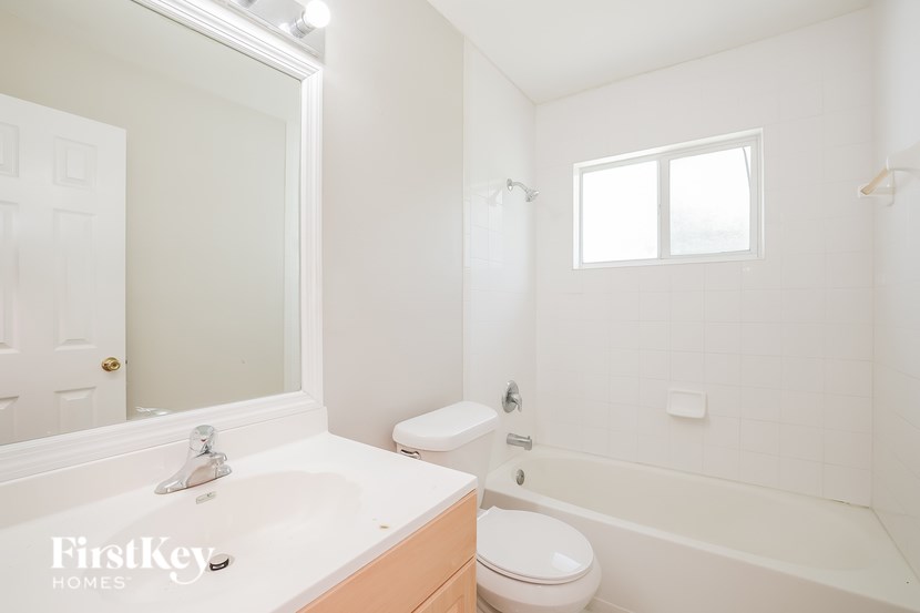 A white bathroom with a sink, toilet, and bathtub.