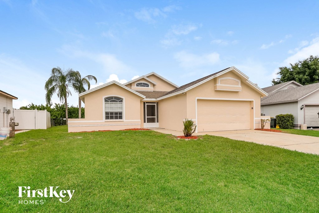 A house with a well-maintained lawn and a clear sky.
