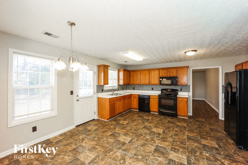 a kitchen with wood cabinets and black appliances