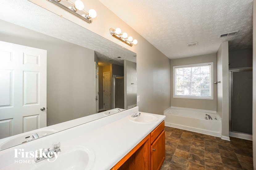 a bathroom with a large mirror and a sink