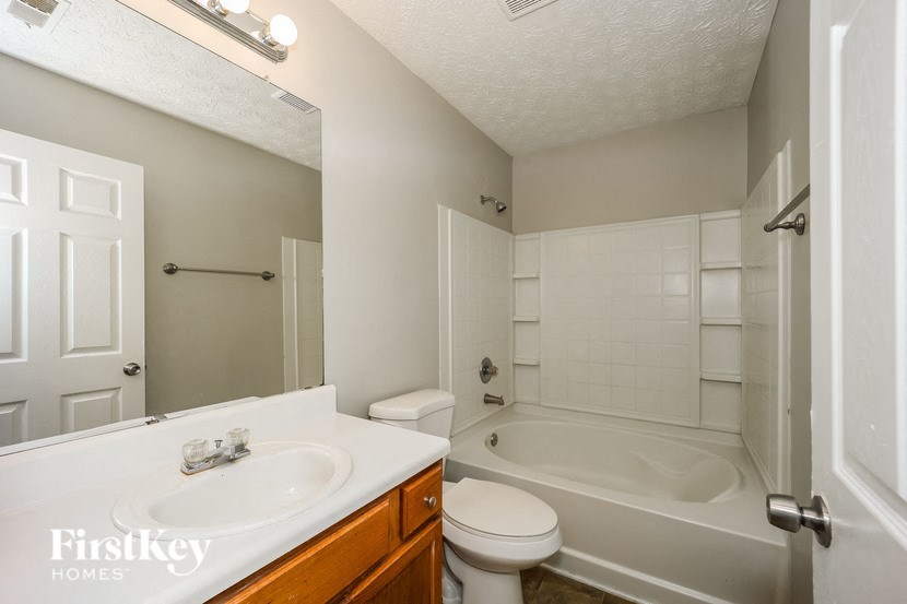 a bathroom with a sink toilet and a tub
