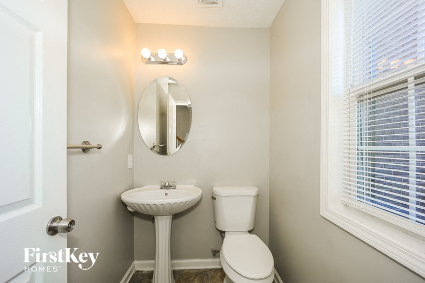 a small bathroom with a sink toilet and a mirror