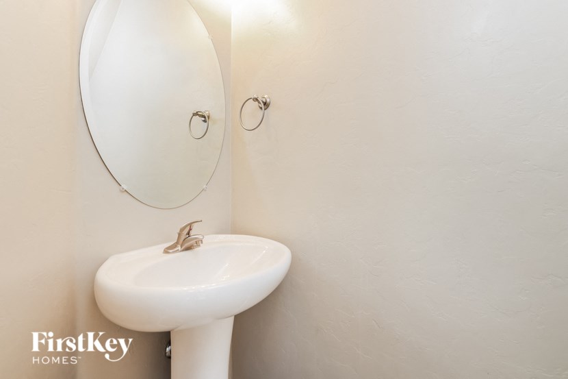 a white bathroom with a sink and a mirror