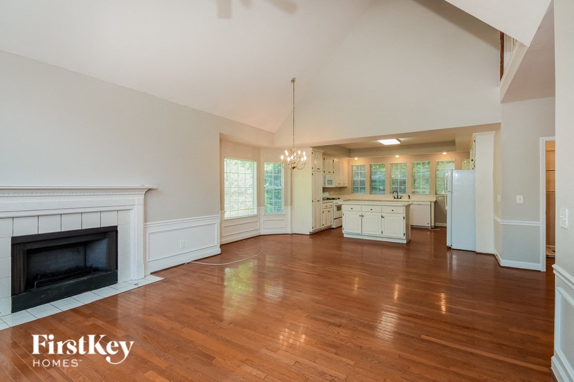 a large living room with a fireplace and a wooden floor