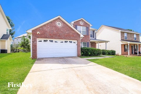 A house with a garage is for sale by First Key Homes.