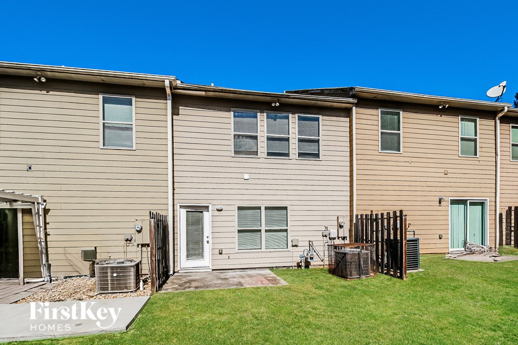 A row of houses with the logo "FirstKey Homes" on the front yard.