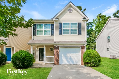 a beige house with a white garage door