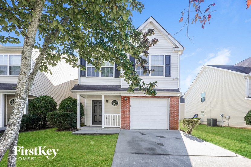 A house with a garage is for sale.