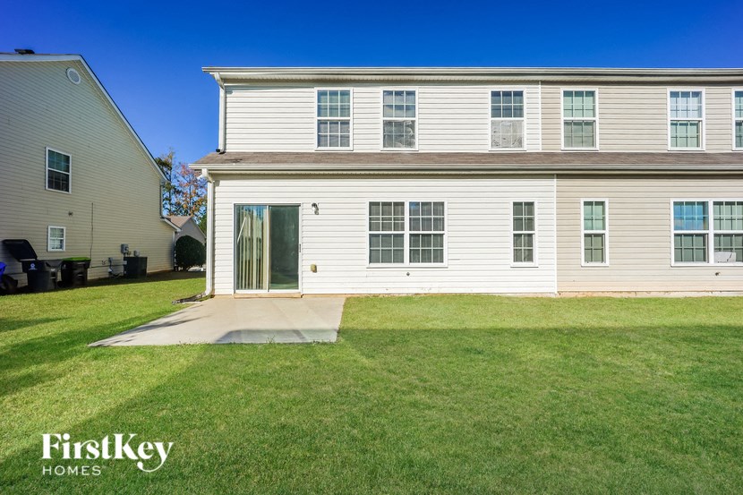 A two-story house with a lawn in front.