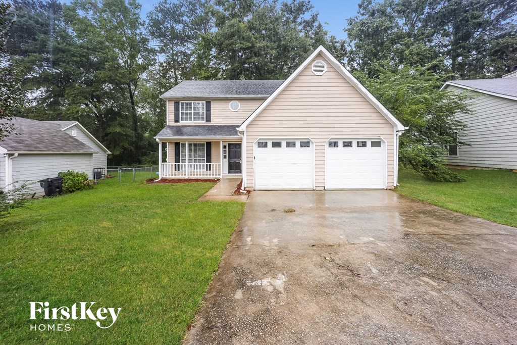 a house with a driveway and a white garage door