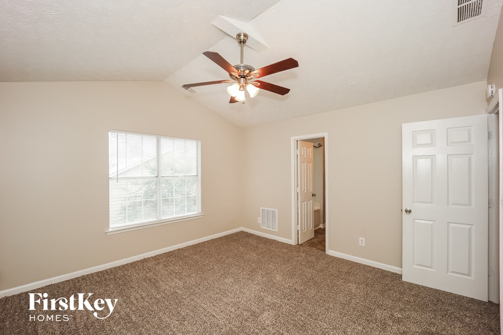 the master bedroom is spacious and has a ceiling fan
