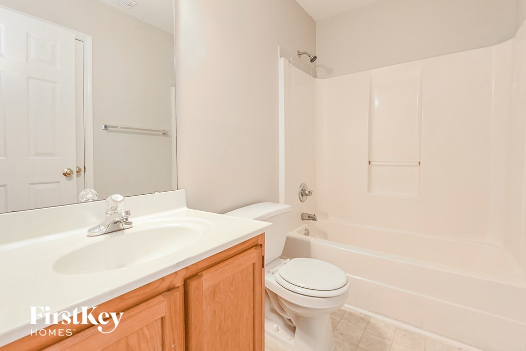 a bathroom with a sink and a toilet and a tub
