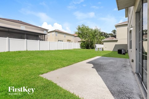 the yard of a house with a driveway and grass