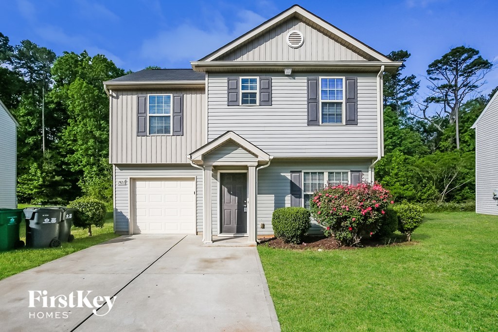 A two-story house with a garage is for sale.