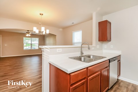 A kitchen with a sink and a FirstKey Homes logo.