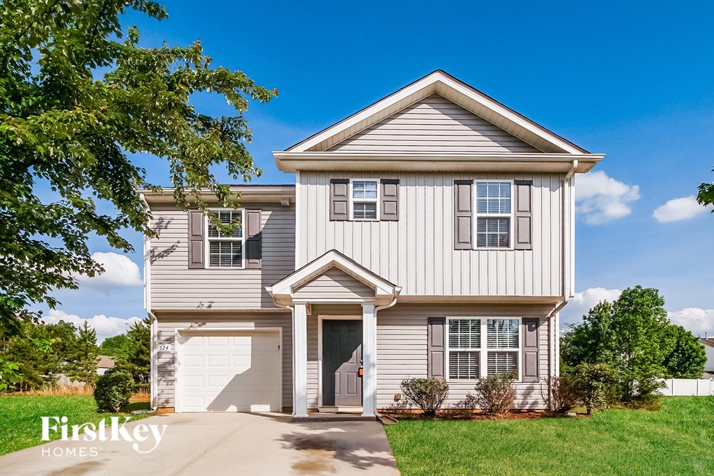 A house with a garage and a driveway is for sale.