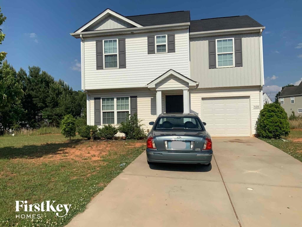 a car parked in a driveway in front of a house