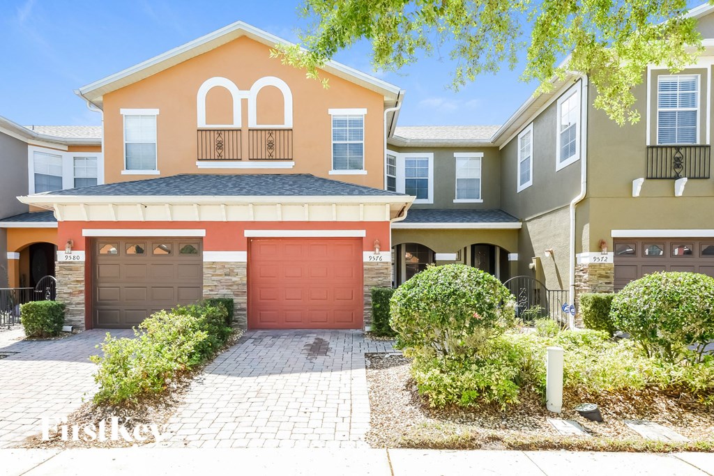 a house with a red garage door in front of it