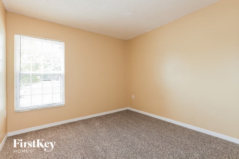 a room with carpet and a window