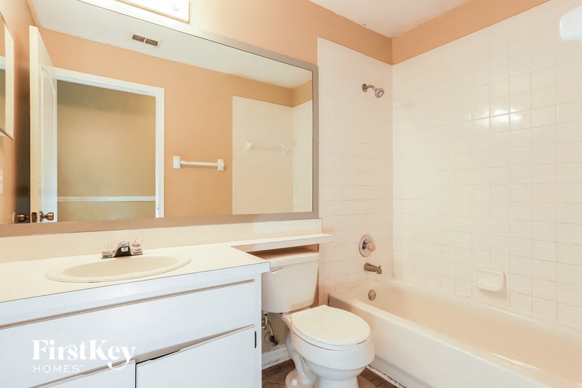 a bathroom with a sink toilet and a bath tub