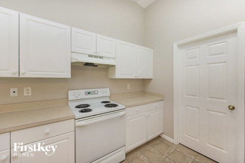 a white kitchen with white appliances and white cabinets