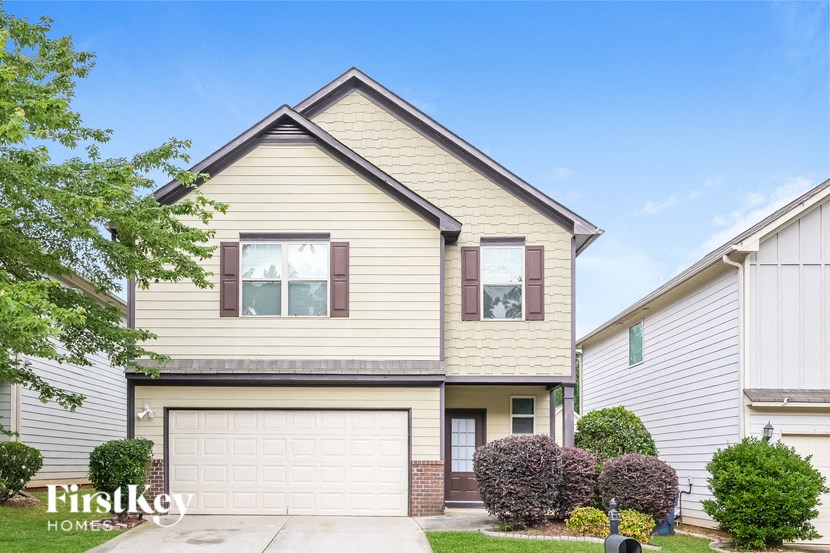 a yellow house with a white garage door