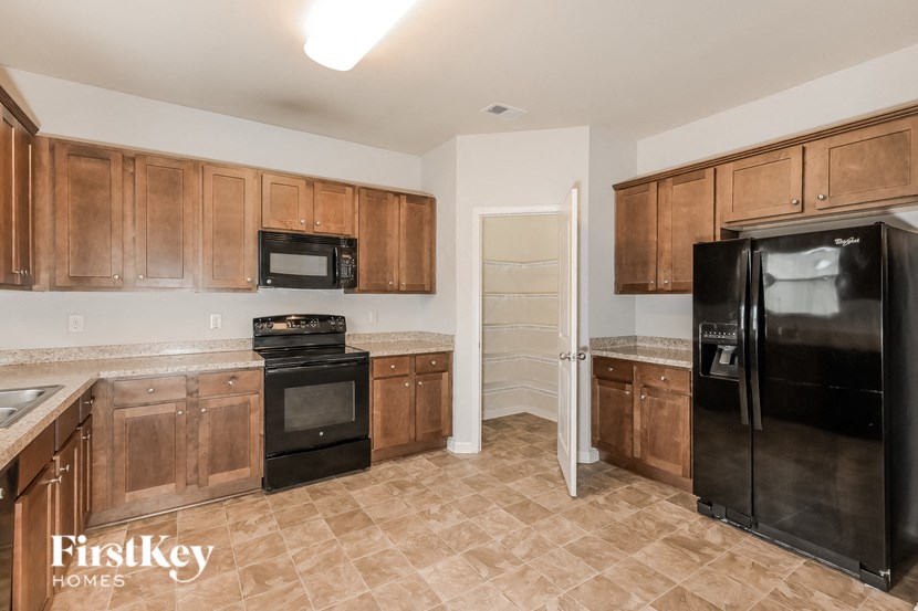 a kitchen with black appliances and wooden cabinets