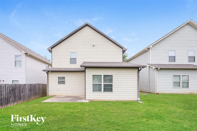 a home with white siding and a green lawn