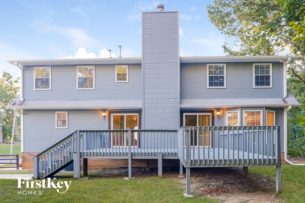 a blue house with a porch and a deck