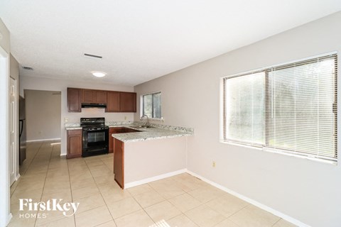 A kitchen with a stove top oven and a sink.