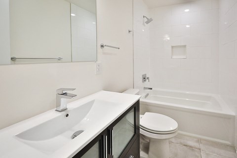 a bathroom with a sink and a toilet and a bath tub