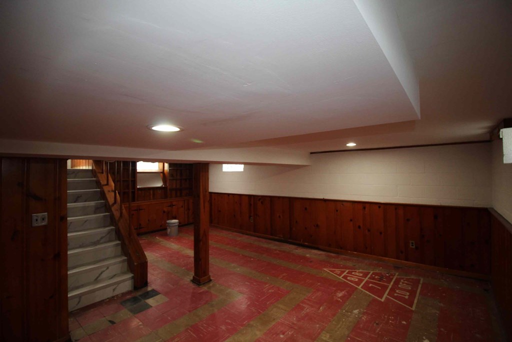 a large room with a staircase and a carpeted floor