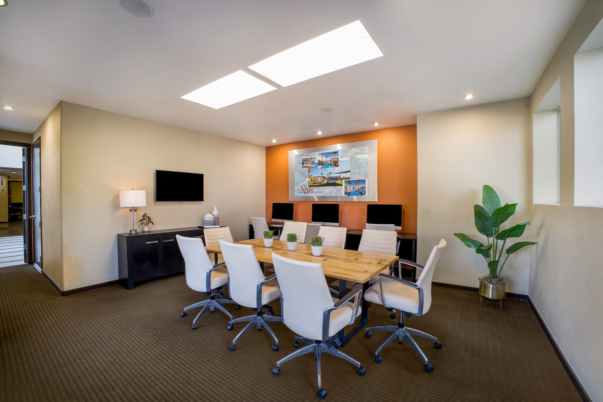 a conference room with a wooden table and chairs