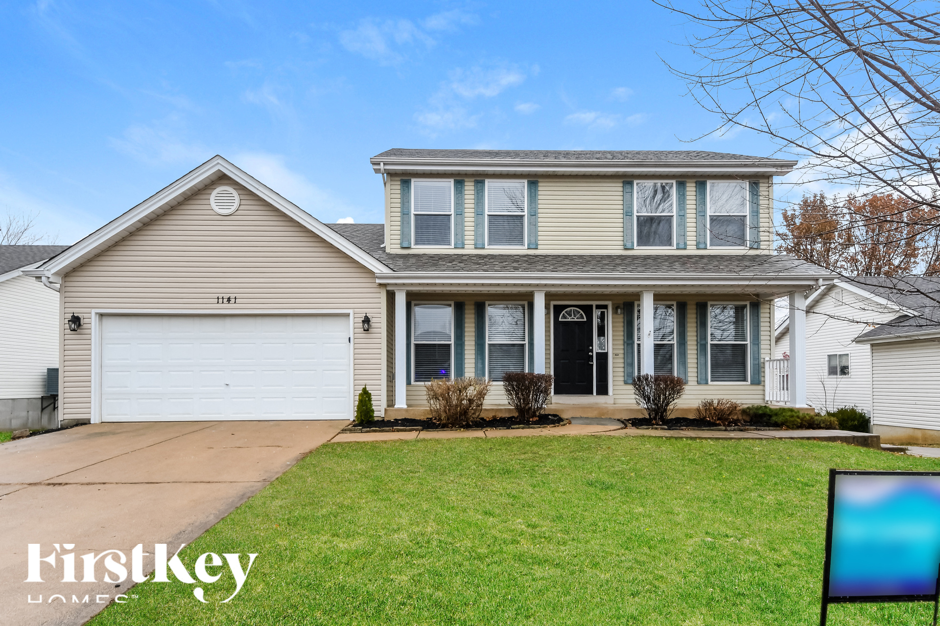 a beige house with a white garage door