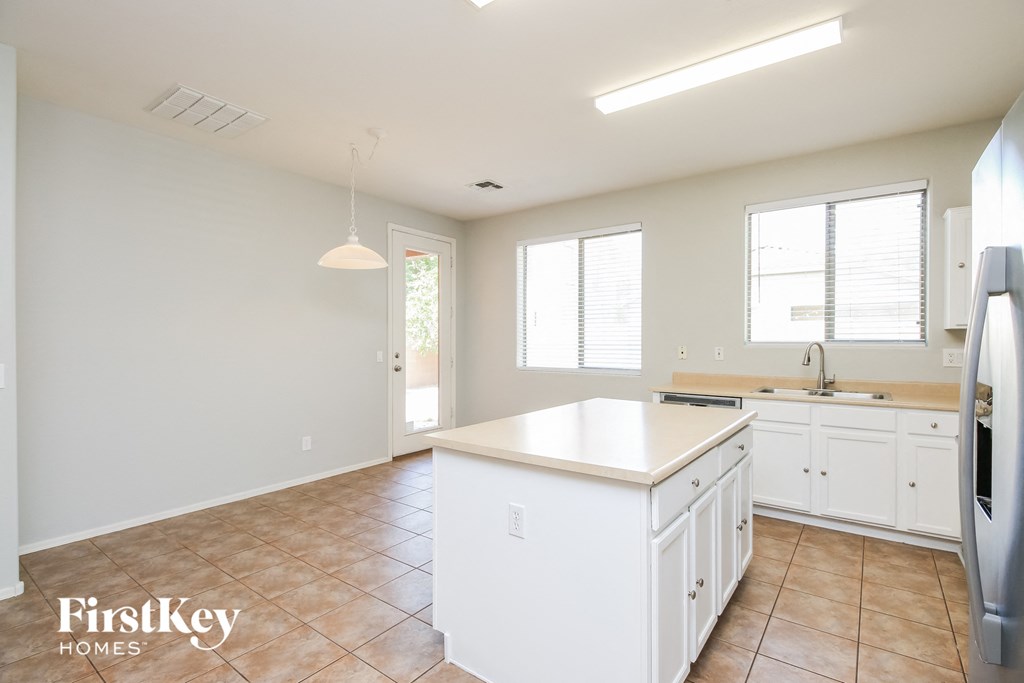 a kitchen with white cabinets and a white counter top