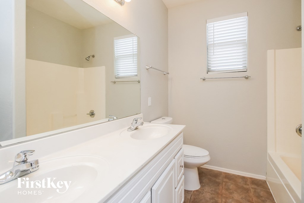 a bathroom with a toilet and a sink and a mirror