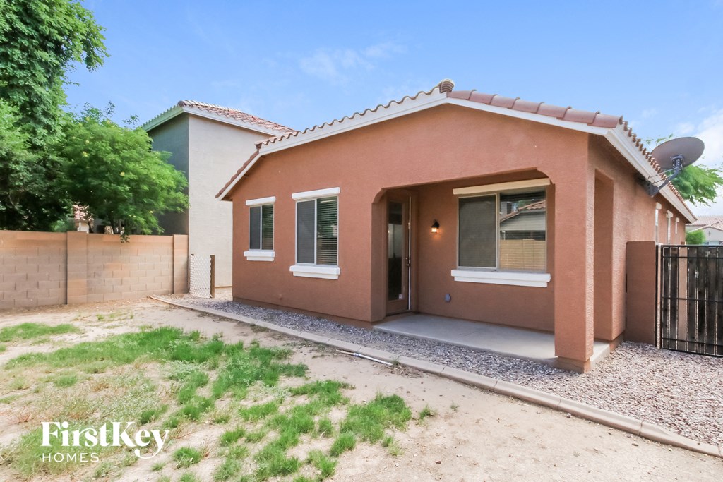 a small house with a yard and a gate