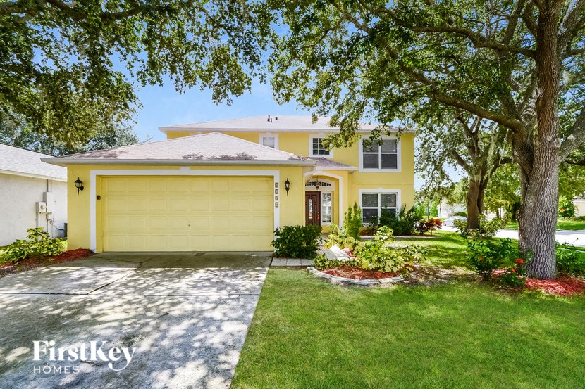 a yellow house with a yellow garage door