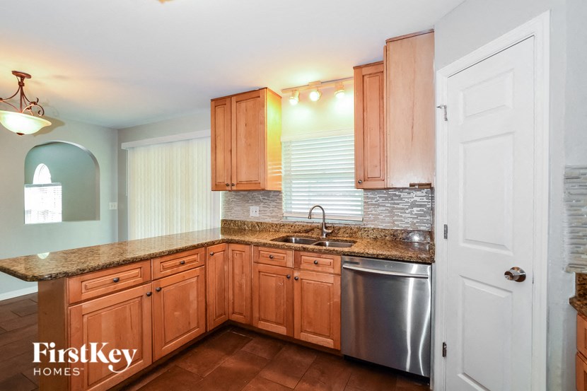 a kitchen with wooden cabinets and stainless steel appliances