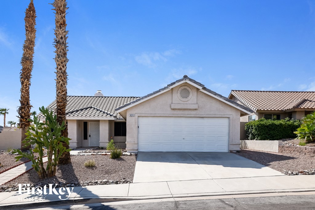 A house with a white garage door is for sale.