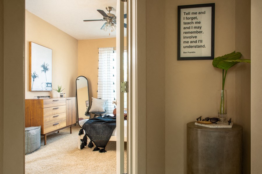 A room with a quote on the wall and a baby stroller.