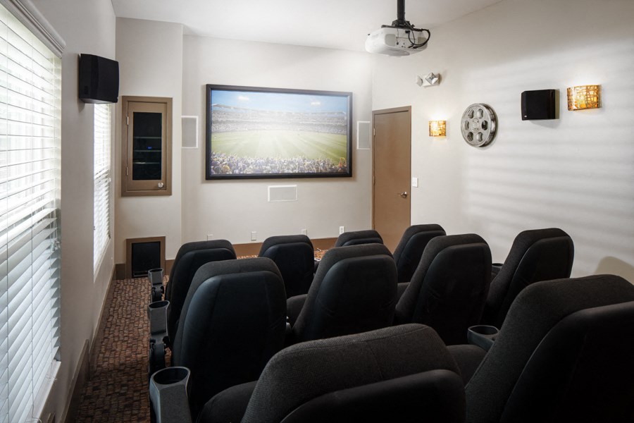 A room with a row of chairs and a television mounted on the wall.