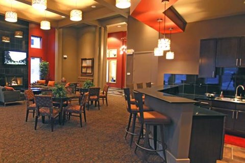 A kitchen with a dining table and chairs.