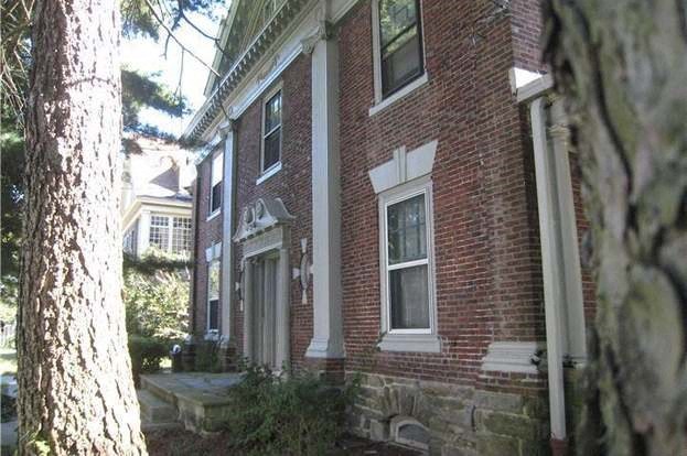 a brick house with a tree in front of it