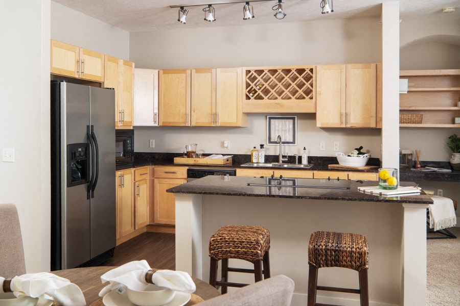 a kitchen with stainless steel appliances and wooden cabinets