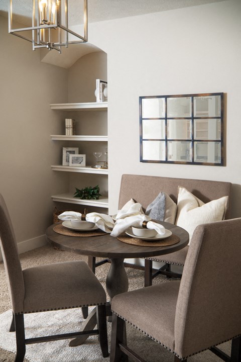 a small dining room with a table and chairs