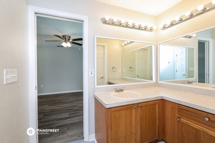 a bathroom with a large mirror and a sink